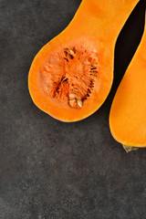 Cut the pumpkin in half on a black background. Top view .