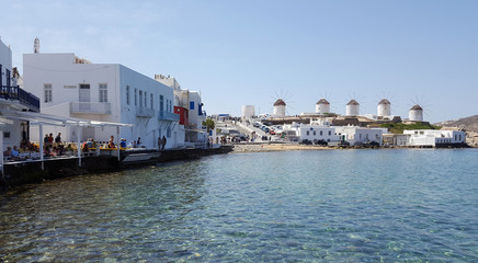 View of the famous windmills of Mykonos island from Little Venice restaurant