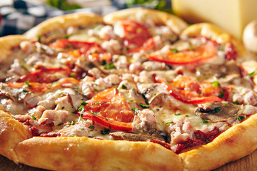Pizza Restaurant Menu - Delicious Fresh Pizza with Mushrooms, Tomatoes and Meat. Pizza on Rustic Wooden Table with Ingredients