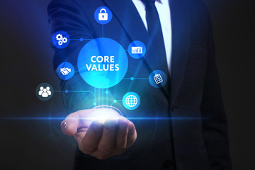 Fototapeta premium Business, Technology, Internet and network concept. Young businessman working on a virtual screen of the future and sees the inscription: Core values
