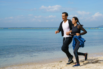 Couple jogging along the beach
