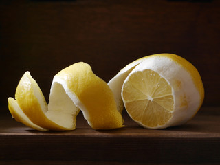 Cut lemon with peel on a wooden dark background. Healthy eating concept, vegetarian, vegetable healthy food.