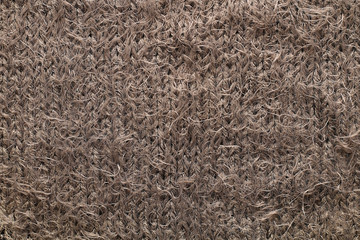 Texture of a fragment of a warm winter female soft fluffy brown sweater