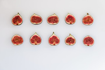 Pattern of sliced ripe figs in the form of rectangle isolated on white background. Fruit illustration. Food photo. Flat lay, Top view.