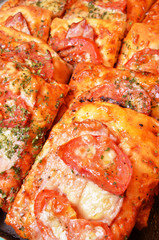 Pizza breads with chess and tomatos at the bakery  