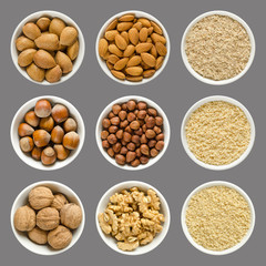 Almonds, hazelnuts and walnuts in bowls. Whole, shelled and grounded nuts in white china. Prunus...