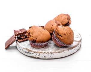 homemade chocolate muffins on a wooden board