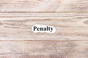 penalty of the word on paper. concept. Words of penalty on a wooden background