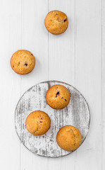 homemade muffins on a white wooden background