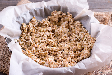 Granola on parchment paper before being baked