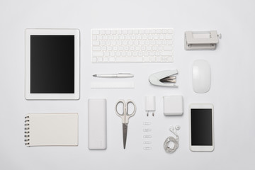White office supplies. Digital tablet and smartphone on white table background with copy space.