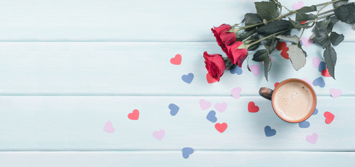 Roses with coffee cup and paper hearts with place for text on background of shabby wooden planks