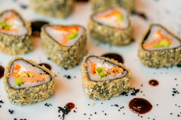 Close up delicious triangle sushi rolls on plate