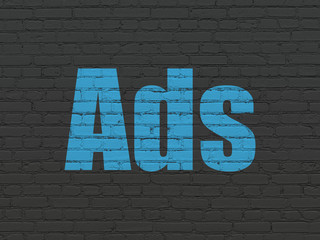 Advertising concept: Painted blue text Ads on Black Brick wall background