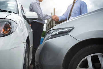 Insurance Agent and customer shaking hands, Traffic Accident and insurance concept