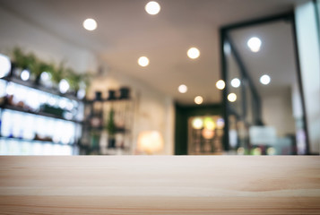 Fototapeta premium Empty wooden table and blurred background of abstract in front of restaurant or coffee shop for display of product or for montage