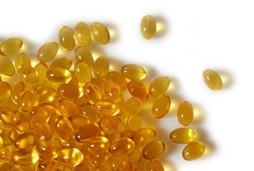 Omega-3 fish fat oil capsules close up on a white background.