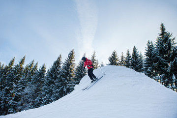 Full length shot of a woman skiing in the mountains