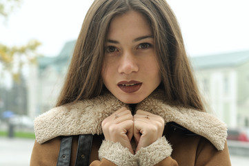 Close-up portrait of a girl who is walking along the street