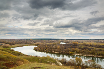 Autumn landscape on the hills of the River Don. View of the pond on a background of cloudy sky ..