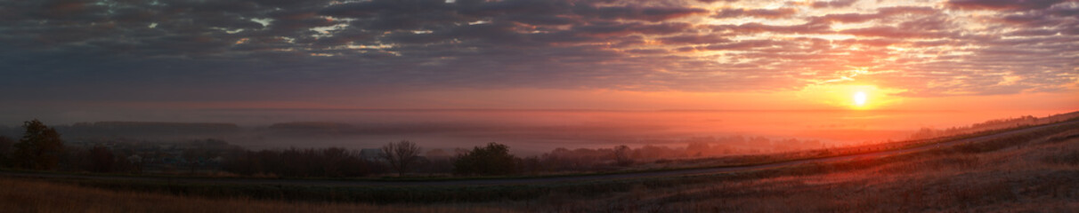 Panoramic landscape with fog in the background of the rising sun.