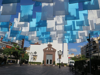 Blue and white flags in church square