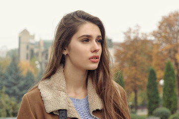 Close-up portrait of a beautiful girl with long brown hair