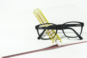 Glasses on notebook in concept education.