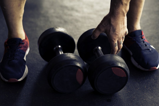 Close up of two dumbbells lying on the floor