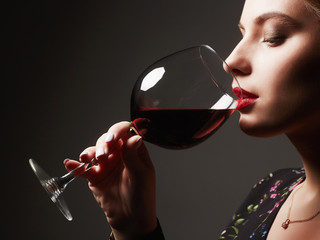 Beautiful young woman drinking wine
