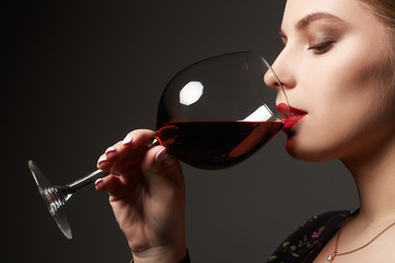 Beautiful woman drinking red wine