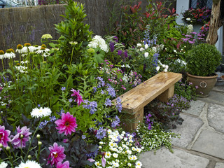 Garden seating in a colorful flower garden