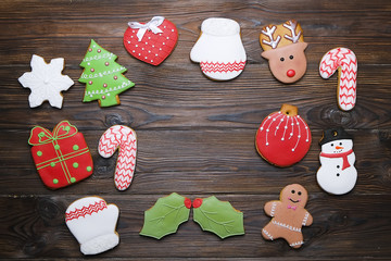Christmas homemade gingerbread cookie frame on wooden table top view with copy space