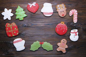 Christmas homemade gingerbread cookie frame on wooden table top view with copy space