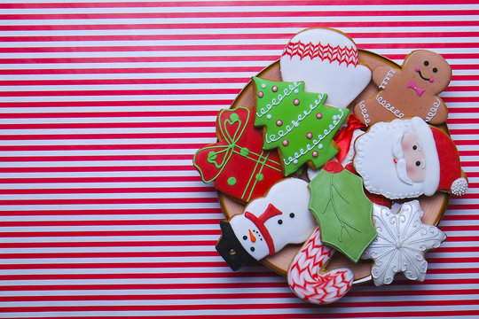 Christmas cookies on stripe background top view. Various types christmas gingerbread cookies flat lay. Christmas characters cookies. Christmas cookies background - Powered by Adobe