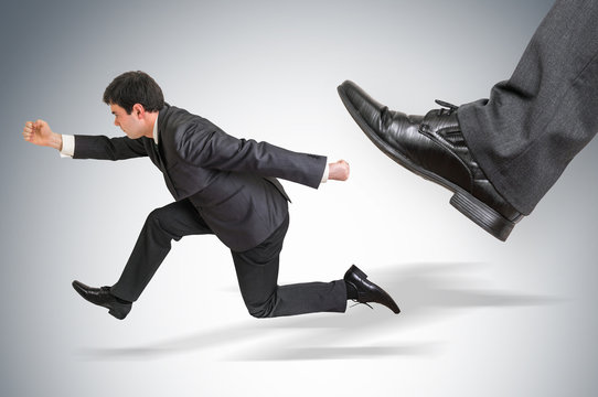 Small businessman running away from a boss pressure