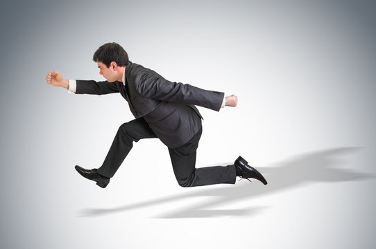 Businessman with suit running away from a boss pressure