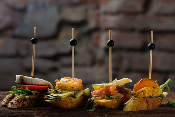 Tapas on Crusty Bread - Selection of Spanish tapas served on a sliced baguette.