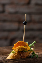 Tapas on Crusty Bread - Selection of Spanish tapas served on a sliced baguette.