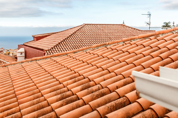 Some roofs of some houses with orange tiles