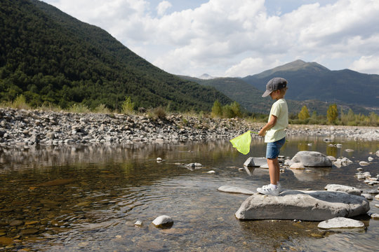 Boy fishing with hoop net