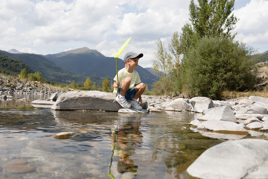 Boy fishing with hoop net