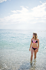 Beautiful model relaxing on a beach dressed in a swimsuit.
