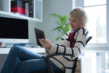 Woman using digital tablet at home