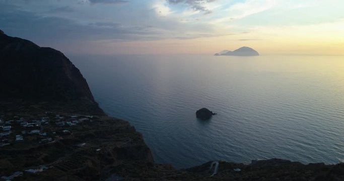 discovering aerial view of mediterranean sea ocean town pollara at sunset or sunrise.Nature outdoors travel establisher,Italy,Sicily Eolian Salina Island.Summer or spring.4k drone establishing video