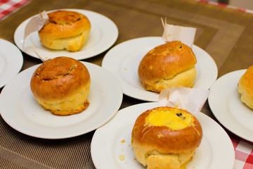 children prepare a stuffed bun of raw ingredients