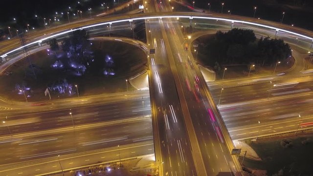 Aerial timelapse: Cars moving on flyover of Moscow beltway and night city lights