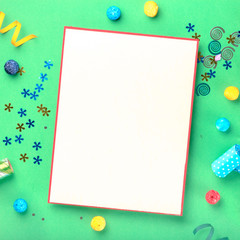 Blank card with different celebratory items on green background