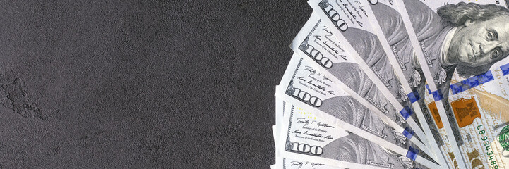 Hundreds american dollars on a black background
