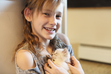 10 years old girl with kitten at home